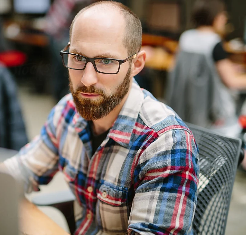 An engineer at his desk in an open-plan office