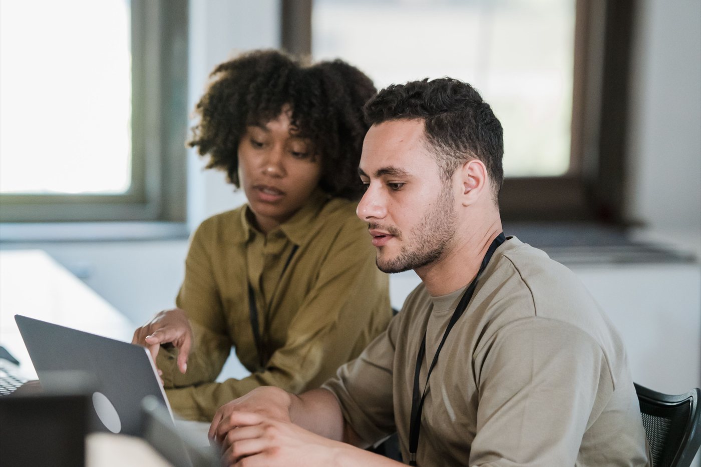 Two colleagues working through a design on a laptop