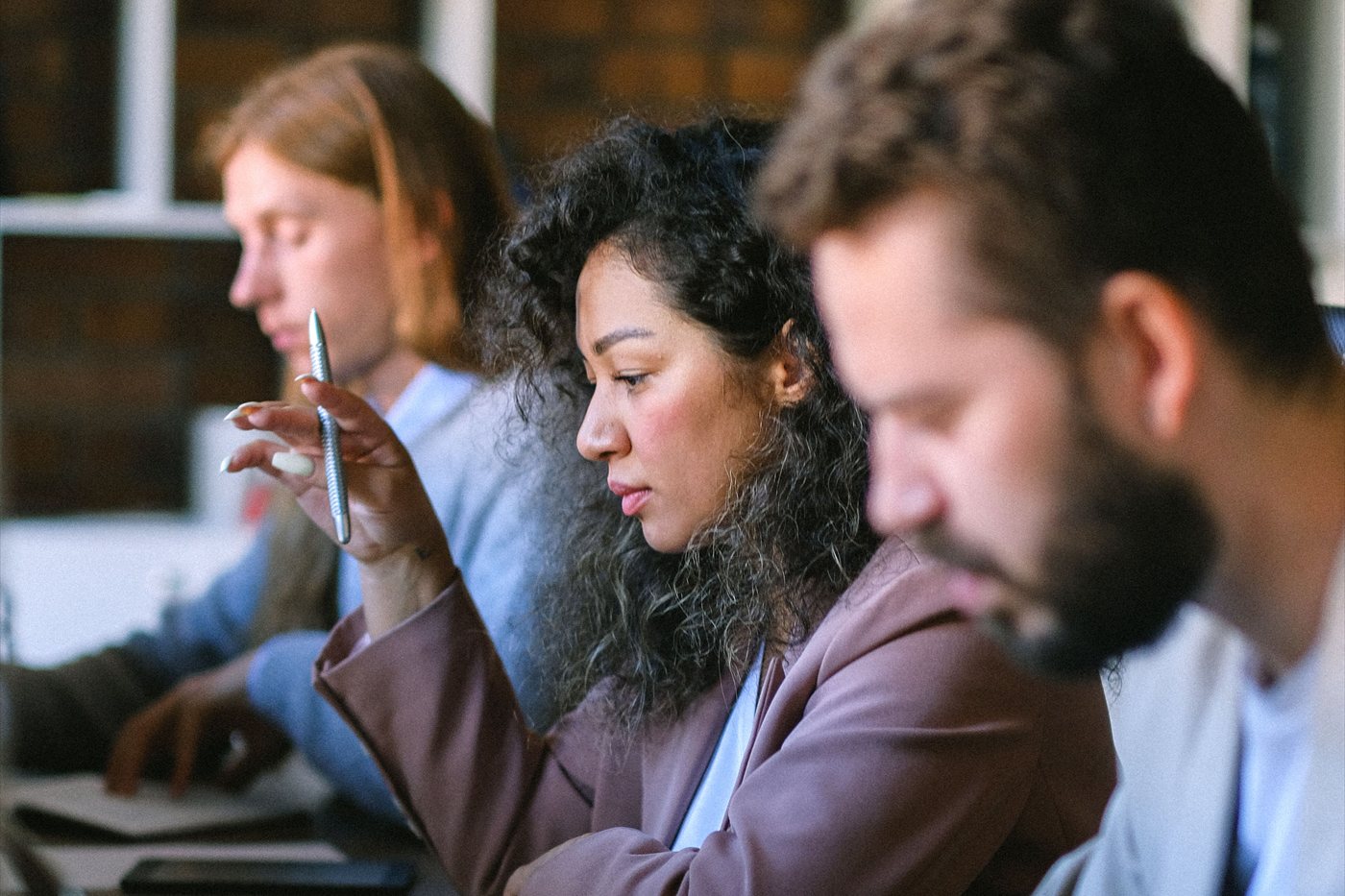 A delivery team working side by side at a shared desk